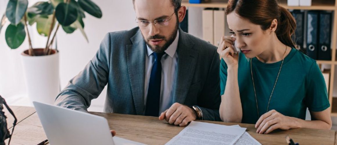 Solicitors reviewing a case on a laptop