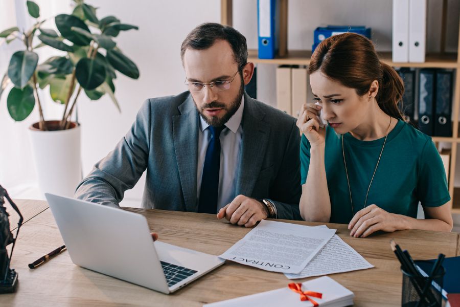 Solicitors reviewing a case on a laptop